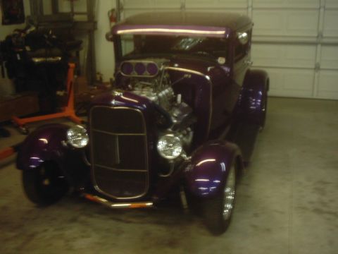 1978 Ford Bronco - A custom purple hot rod with a large engine is parked indoors.