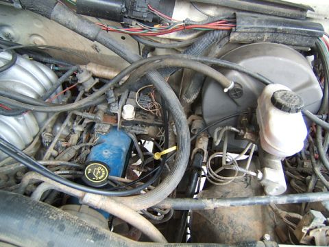 1988 Ford Bronco - Close-up view of an engine bay, showing mechanical components and wiring harnesses.