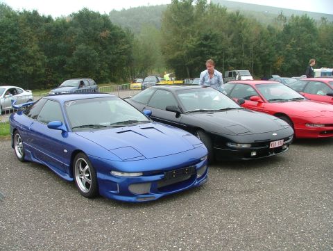 1994 Ford Probe - Several Ford Probes are parked in a lot, with a blue one in the foreground.
