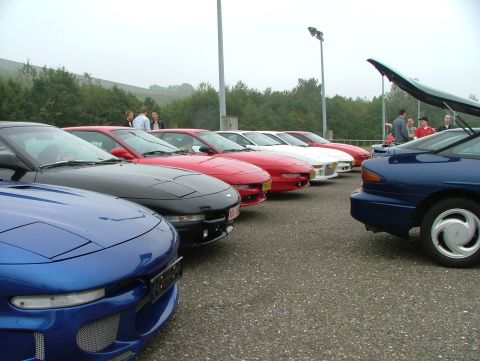 1994 Ford Probe - A gathering of 1994 Ford Probes, the distinctive front-end design of the blue car in the foreground.
