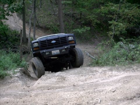 1986 Ford Bronco - This 1986 Ford Bronco navigates a challenging off-road trail with steep inclines.
