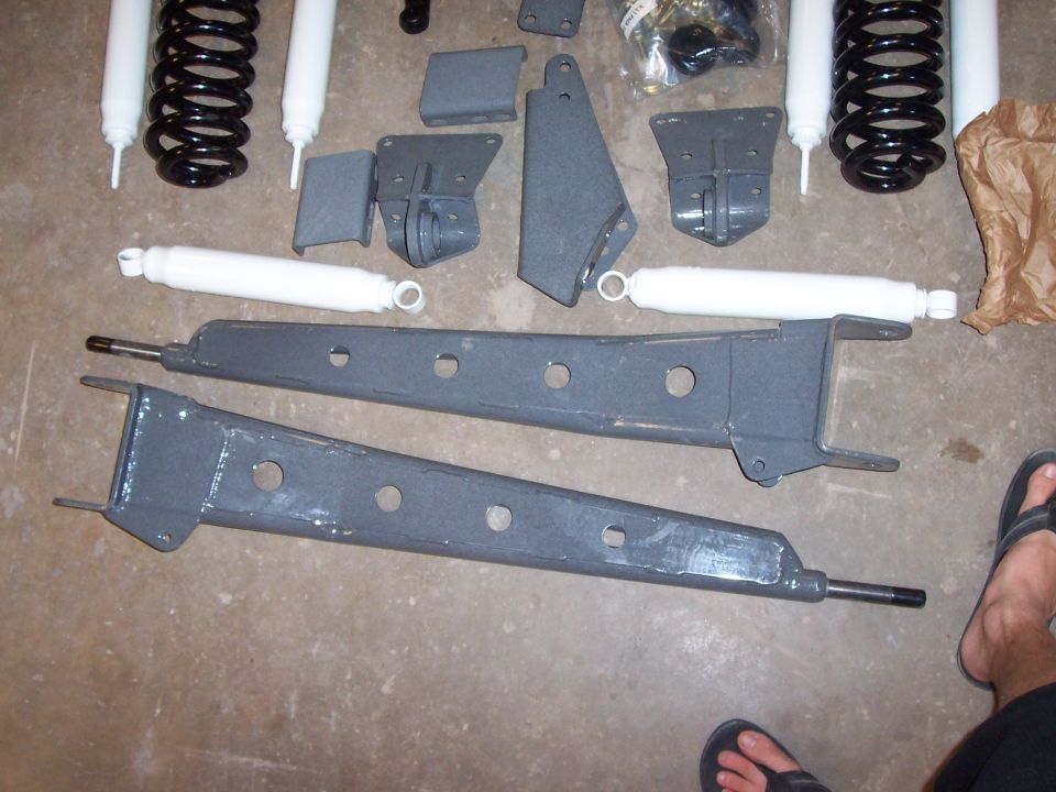 Gray lift kit components including shocks and control arms