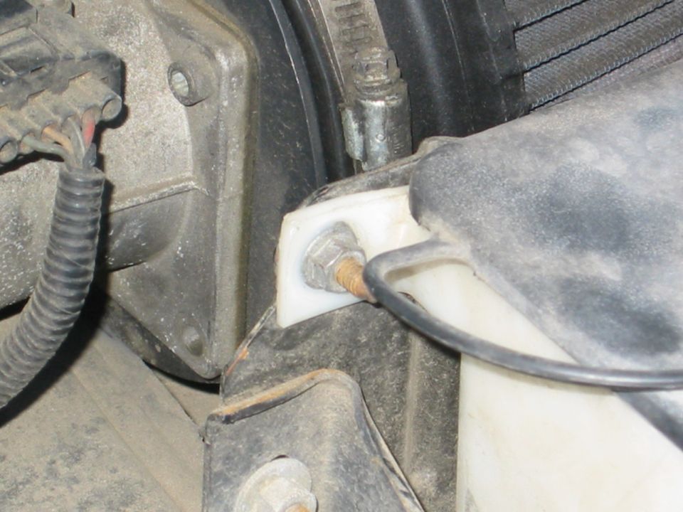 for the driver's side, same song except you need to remove the radiator overflow and washer fluid bay.  
IE - this nut and for me a zip tie on the other side.