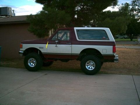 1988 Ford Bronco - This lifted Ford Bronco has a two-tone paint scheme and large off-road tires.