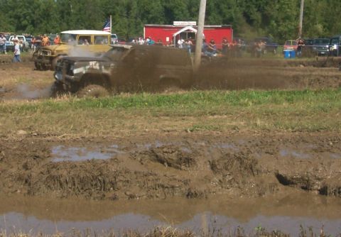 1979 Ford F-150 - A vehicle navigates a muddy obstacle course during an event.