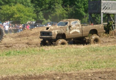 1979 Ford F-150 - Mud bogging event with a heavily modified pickup truck navigating a muddy track.