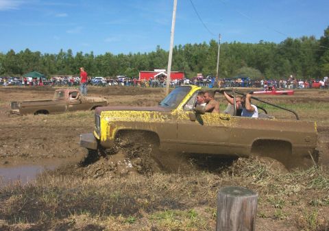 1979 Ford F-150 - Mud bogging event with multiple trucks stuck in the mire.