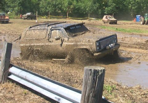 1979 Ford F-150 - This SUV is deep in the mud during a bogging event, with other vehicles visible in the background.