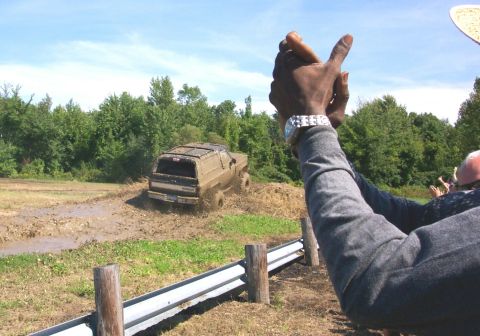 1979 Ford F-150 - SUV navigating a muddy track with spectators observing the action.