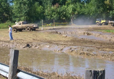 1979 Ford F-150 - Muddy off-road course with a 1979 Ford F-150 and a yellow Jeep participating.
