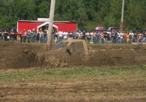 1979 Ford F-150 - Truck stuck deep in mud during an event, with a crowd watching.