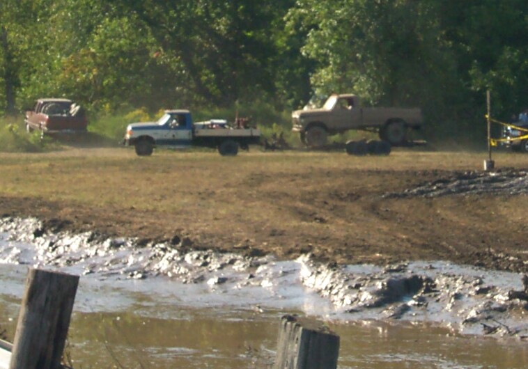 1979 Ford F-150 and other trucks in a muddy field