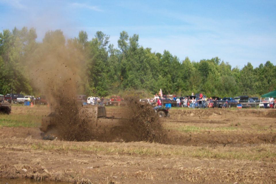 Truck spraying mud high in the air during a mud bog event
