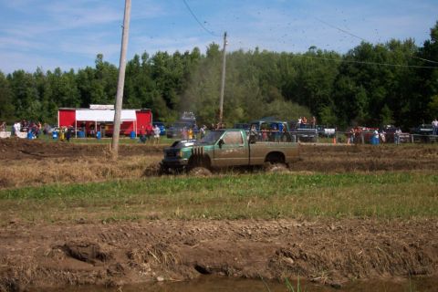 1979 Ford F-150 - Trucks compete in a mud bogging event on a sunny day.