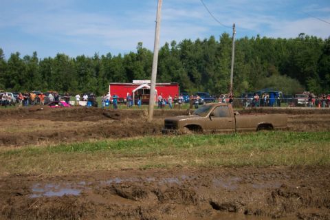1979 Ford F-150 - Pickup truck stuck in mud during an event with people watching.