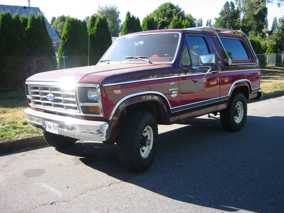 Maroon Ford Bronco parked on street, front 3/4 view. License plate FHM-797