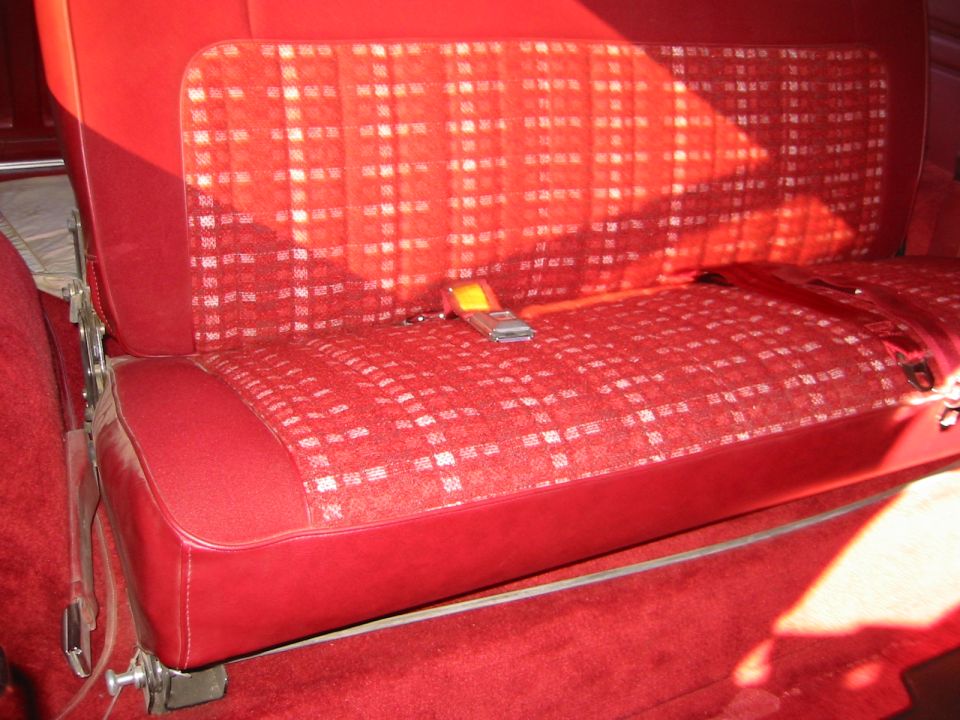 Red plaid rear seat with a yellow seatbelt buckle, 1982 Ford Bronco interior
