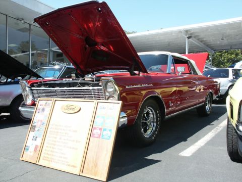 2001 Mercury Grand Marquis - A red 1965 Ford Galaxie 500 convertible is displayed with its hood open at a car show.