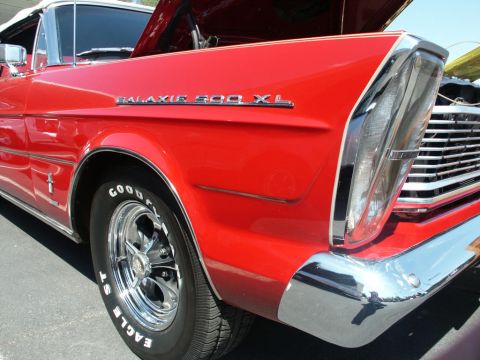 2001 Mercury Grand Marquis - A red 1965 Ford Galaxie 500 XL convertible is shown from the front quarter angle with its hood open.