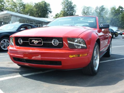 2001 Mercury Grand Marquis - Front view of a red convertible Mustang, likely a 2005 model, in a parking lot.