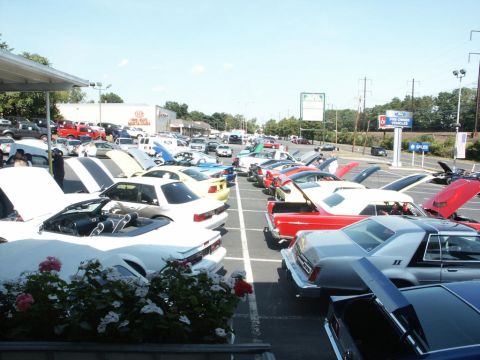 2001 Mercury Grand Marquis - A car show event displays numerous vehicles parked in rows under a clear sky.