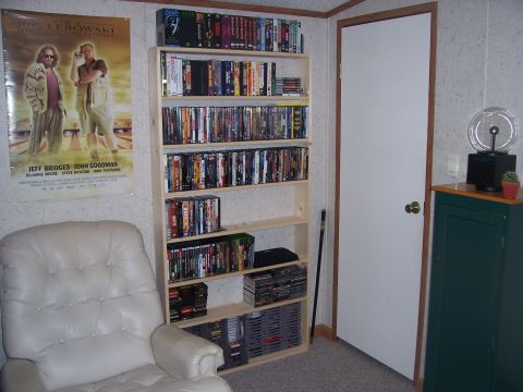 1995 Ford Bronco - Interior room scene a movie poster and shelves packed with DVDs and video games.