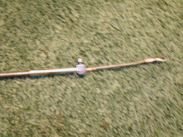 The carb end of the TV cable. The eye fits over a stud on the existing Holley linkage without any modifications. A C-clip retains the cable end to the carb linkage.