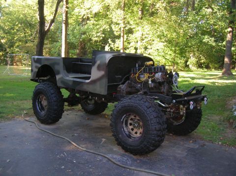 1979 Ford Bronco - Custom Jeep build with large tires and exposed engine, painted in camouflage.