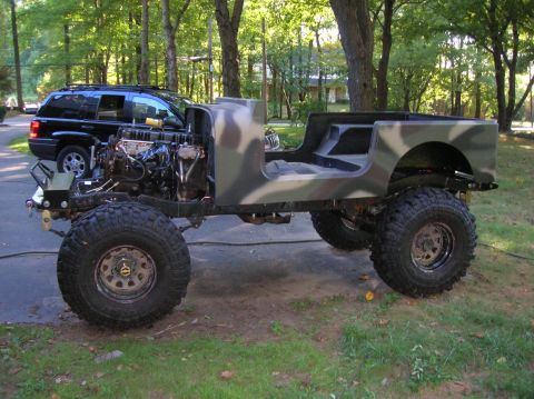 1979 Ford Bronco - Custom Jeep CJ build with a Cummins engine, parked next to a black SUV.