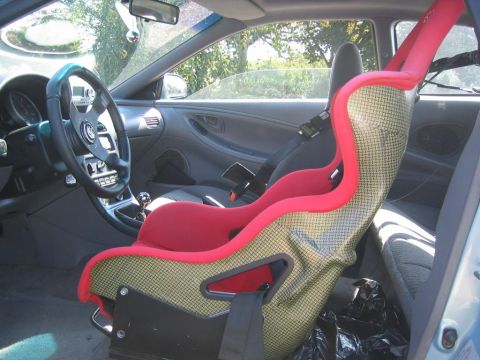 1993 Ford Probe - Interior view of a car's racing seat, showing its red and carbon fiber construction.