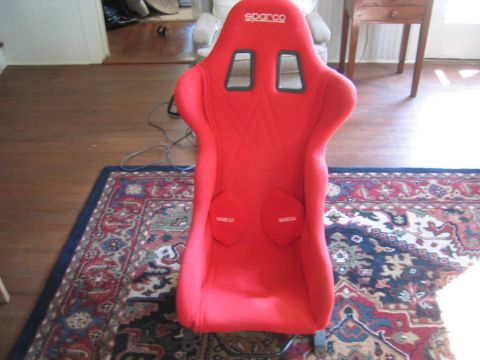1993 Ford Probe - A red racing seat with Sparco branding is shown indoors.