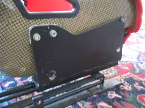 1993 Ford Probe - Close-up of a black metal bracket mounted to a car seat, showing its attachment mechanism.