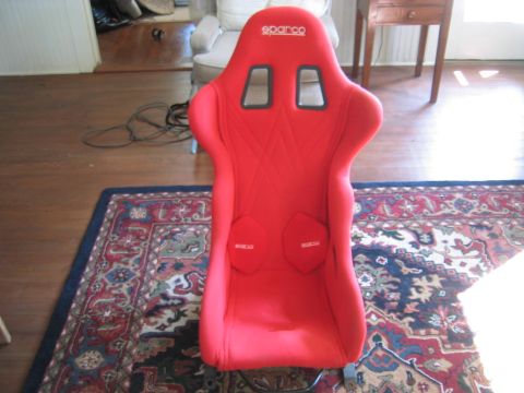1993 Ford Probe - Red Sparco racing seat with black harness cutouts and logos on the seat base.