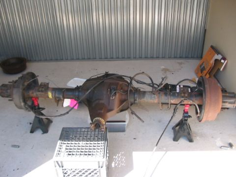 1991 Ford Bronco - A rear axle assembly, likely from a truck or SUV, is shown disassembled and supported by jack stands.