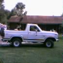 1986 Ford Bronco - Side profile of a 1986 Ford Bronco, showing its classic body style and spare tire carrier.
