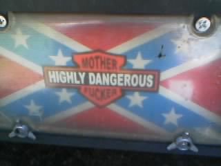 1986 Ford Bronco - License plate features a confederate flag design with a Harley-Davidson-style emblem reading "MOTHER HIGHLY DANGEROUS FUCKER".