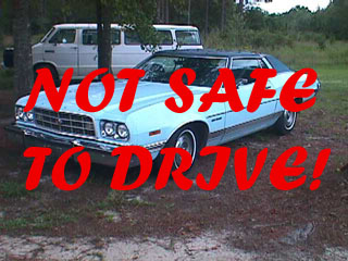 1994 Ford Crown Victoria - Light blue 1970s Ford Granada coupe parked outdoors with a white van in the background.