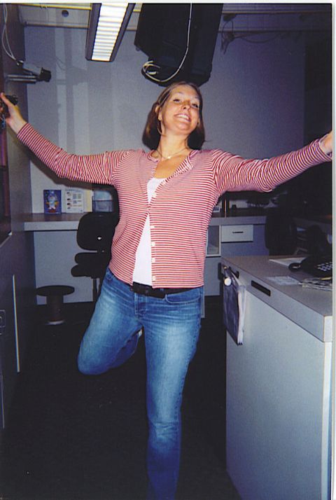 1991 Ford Bronco - A woman strikes a playful pose, balancing on one leg in a casual outfit.