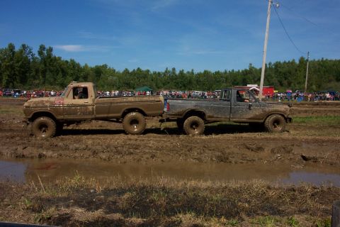 1979 Ford F-150 - Two Ford F-150 pickup trucks, one from 1973, navigate a muddy obstacle course.