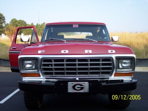 1979 Ford Bronco - Front view of a red 1979 Ford Bronco with the driver's door open.