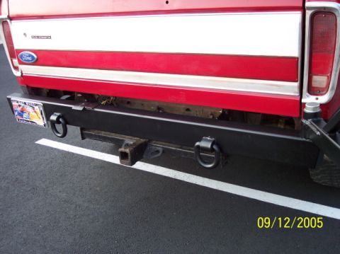 1979 Ford Bronco - Rear view of a 1979 Ford Bronco, showing its bumper, tow hitch, and license plate.
