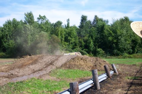 1979 Ford F-150 - A truck navigates a muddy track, kicking up a cloud of dirt and debris.