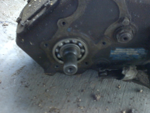 Close-up of a transmission housing with a visible bearing and shaft