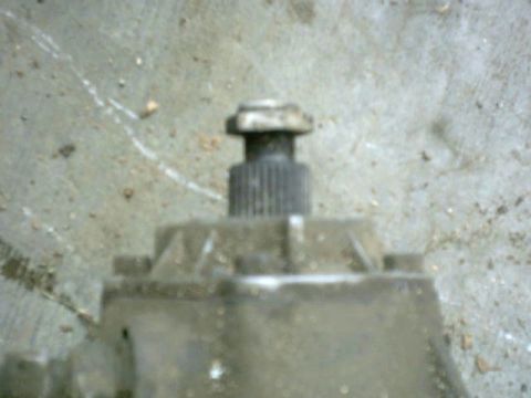 1976 Chevrolet C/K Pickup - A close-up view of a splined shaft extending from a metal component, possibly part of a vehicle's drivetrain.