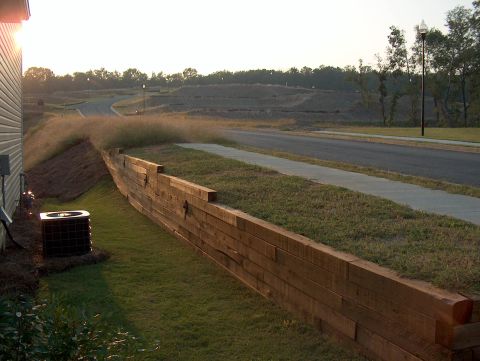 1998 Ford Taurus - A residential construction site is shown with a wooden retaining wall and an AC unit.