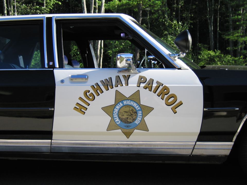 Close-up of HIGHWAY PATROL door lettering and California Highway Patrol star