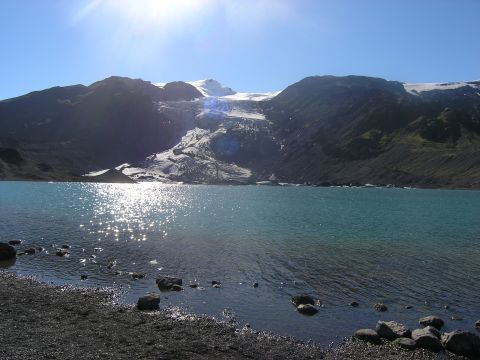 2001 Jeep Wrangler - A scenic view of a glacier feeding a lake under a clear blue sky.