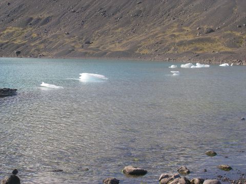 2001 Jeep Wrangler - A scenic view of a lake dotted with icebergs, set against a barren, rocky slope.