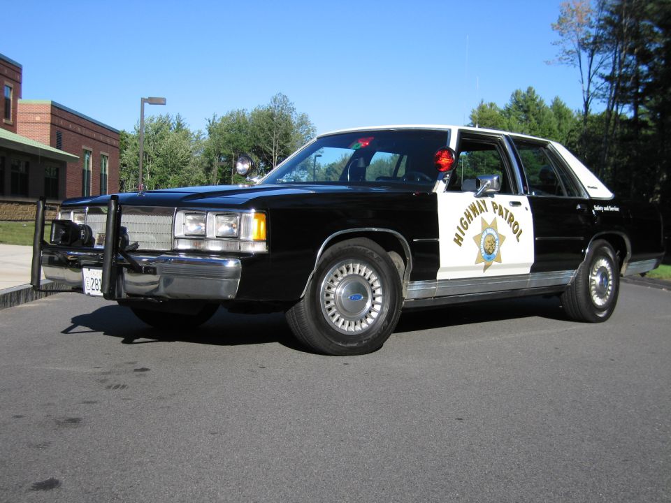 Black-and-white Ford Highway Patrol replica sedan with push bar