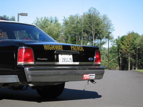 1991 Ford LTD Crown Victoria - Rear view of a Ford-badged Highway Patrol sedan with gold trunk lettering, California plate 281435, and a Drink and Drive bumper sticker.